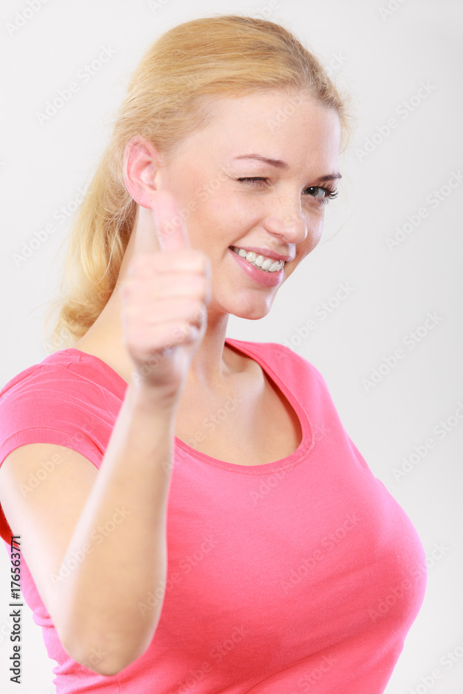 Happy woman showing thumbs up gesture Happy woman showing thumbs up gesture
