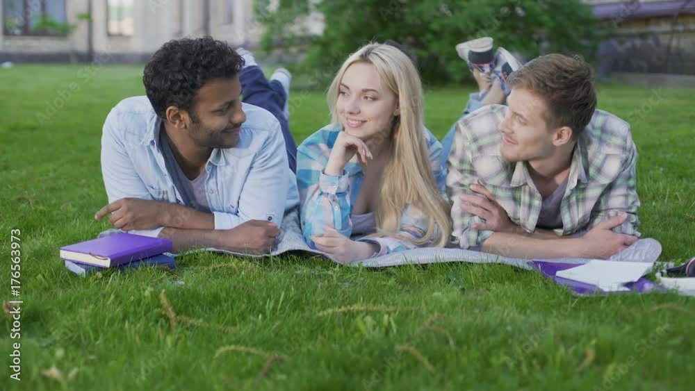 Charming blonde girl flirting with two guys choosing best one, relationship Charming blonde girl flirting with two guys choosing best one, relationship