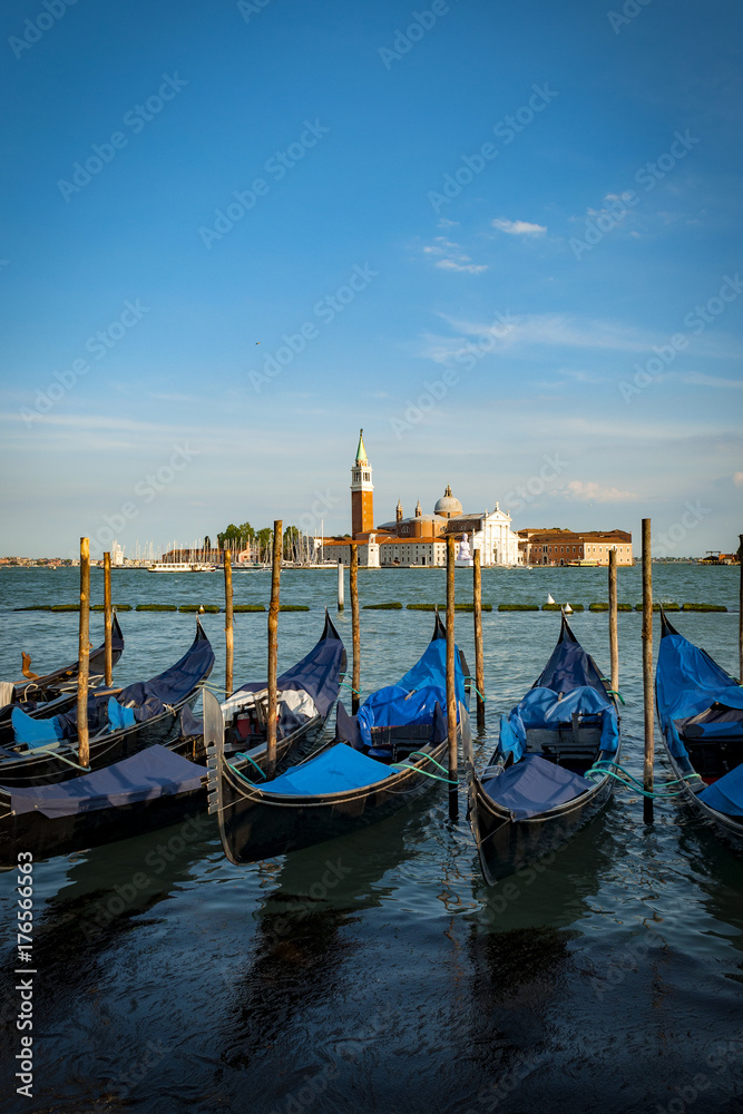 Moored or docked gondolas in Venice, Italy across the lagoon from San Giorgio Maggiore church in the district (sestiere) of San Marco