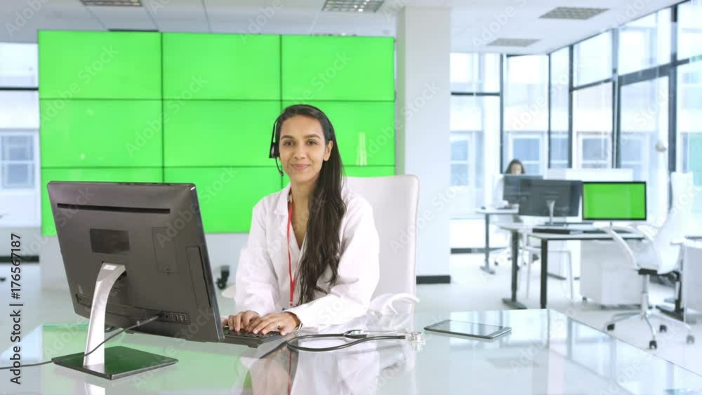 Healthcare worker assisting a patient over the phone, with green background Healthcare worker assisting a patient over the phone, with green background