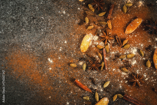 Mixture of dried ground spies for hot spicy tea or indian masala chai - cinnamon, anise, cardamom, ginger, on a white marble table - chili, paprika, curry, turmeric, ginger. Copy space top view