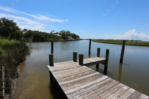 wood dock walkway in waterway © lightrapture