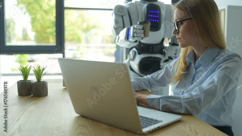 Careful robot bringing girl cup of coffee