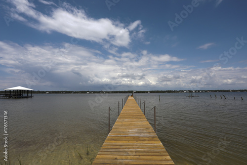 dock into soundside water with sky clouds