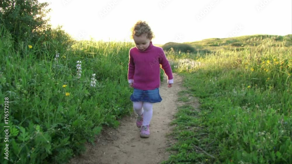 Girl Running on flowered Valley meadow Girl Running on flowered Valley meadow