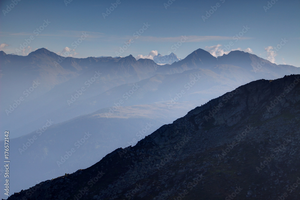 Regenstein, Golbner and Gumriaul peaks, Villgraten / Defereggen Mountain Group, High Tauern with Grossglockner, highest peak of Austria, in the background in a sunlit morning in East Tyrol / Osttirol