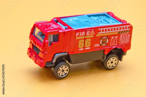 Red toy fire truck / Toy fire engine extinguishes flaming house. Careless handling of fire dangerous for life