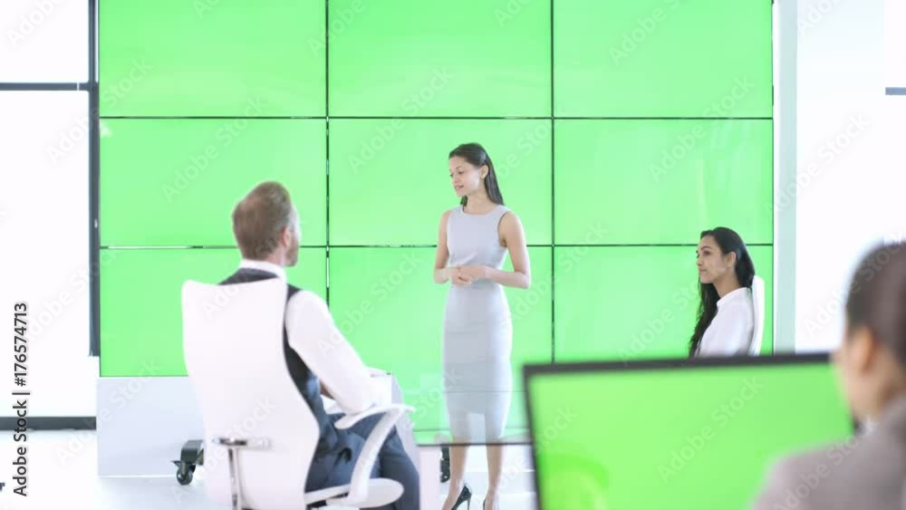  Businesswoman giving presentation & interacting with green screen video wall