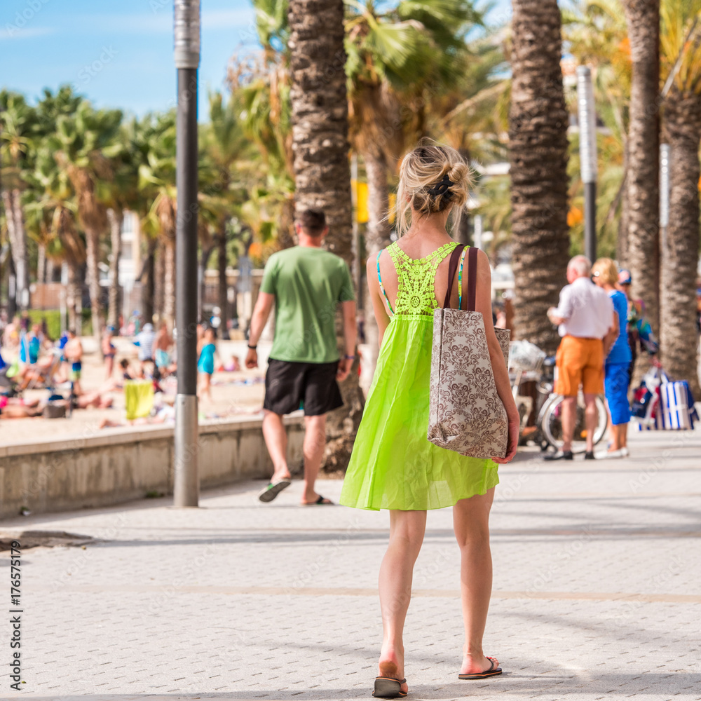 People walk along the embankment, Salou, Tarragona, Spain. Close-up.