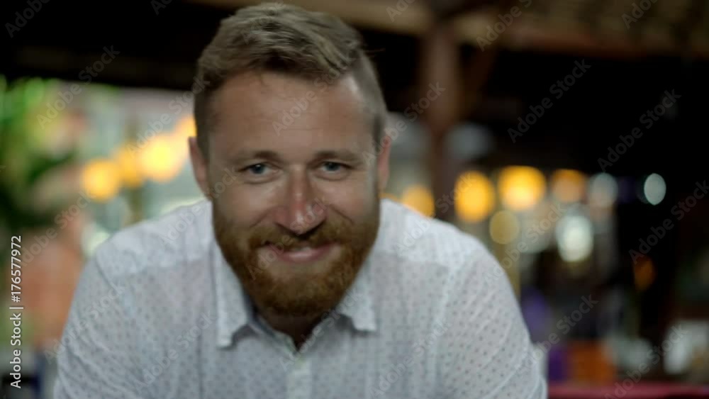 Handsome man smiling to the camera in restaurant, steadycam shot
Handsome man smiling to the camera in restaurant, steadycam shot