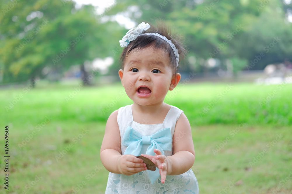 Asian Adorable baby girl playing in park. Beautiful smiling cute baby Asian Adorable baby girl playing in park. Beautiful smiling cute baby