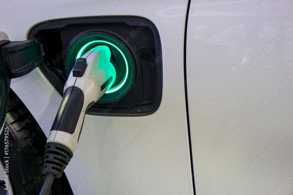 Power supply connect to electric car for add charge to the battery. Charging re technology industry transport which are the future of the Automobile. Power supply connect to electric car for add charge to the battery. Charging re technology industry transport which are the future of the Automobile.