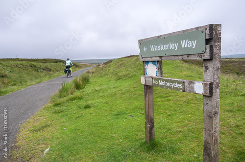 Female cyclist riding along the Waskerley Way in County Durham, UK