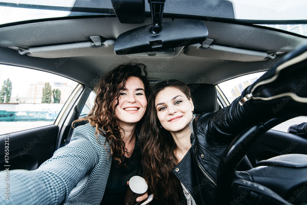 Two girls making selfie in a car Two girls making selfie in a car