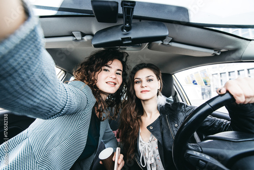 Two girls making selfie in a car