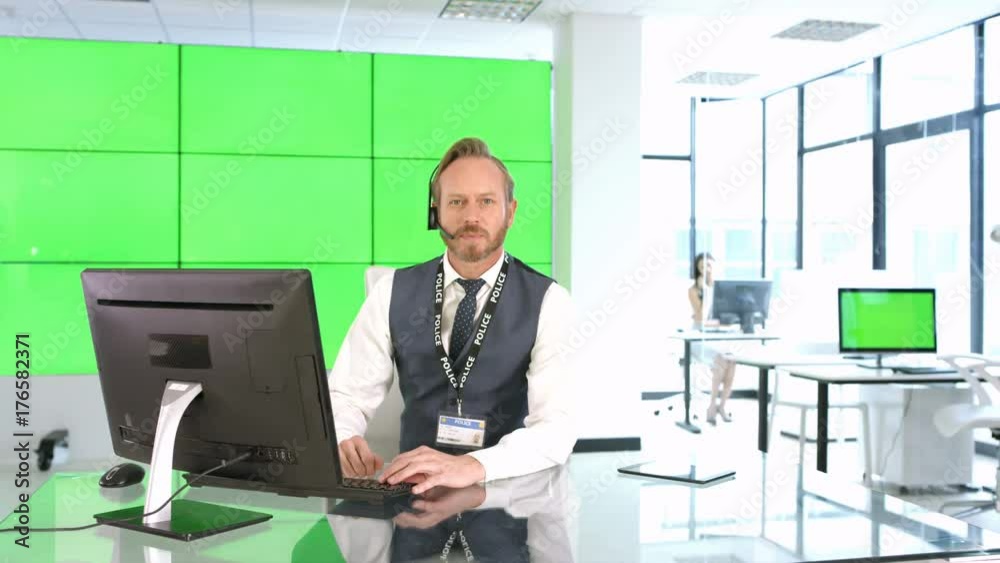 Phone operator with police service assisting a caller, with green background Phone operator with police service assisting a caller, with green background