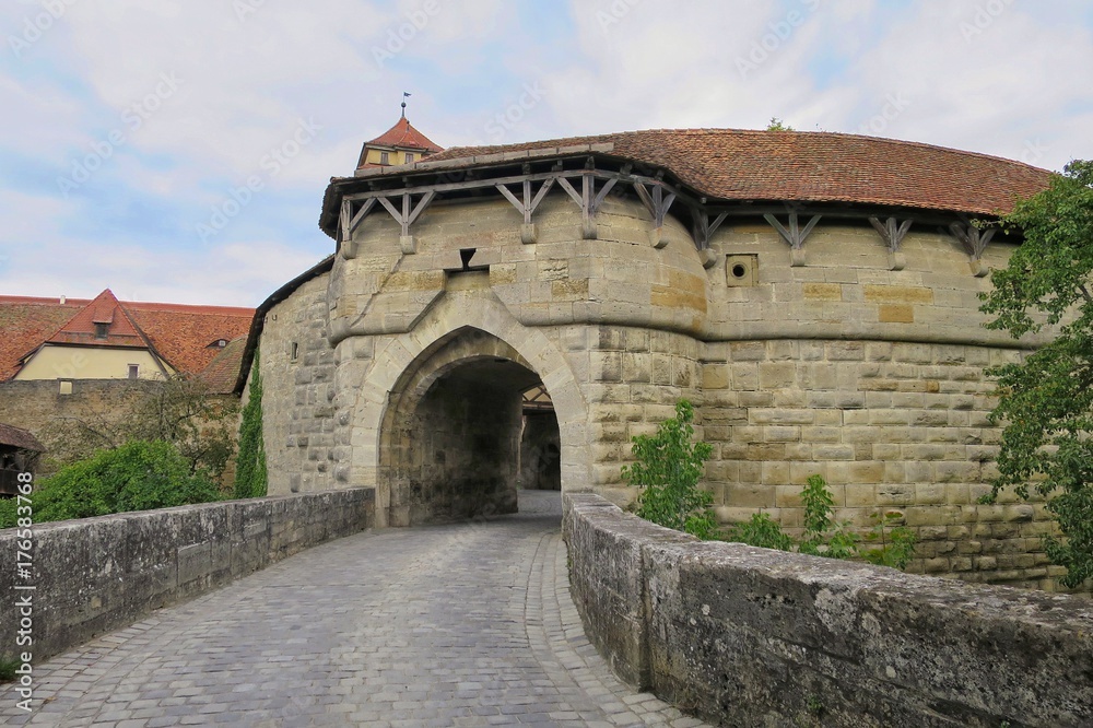 Rothenburg ob der Tauber, Germany with medieval gate and brick walk way in the city wall.