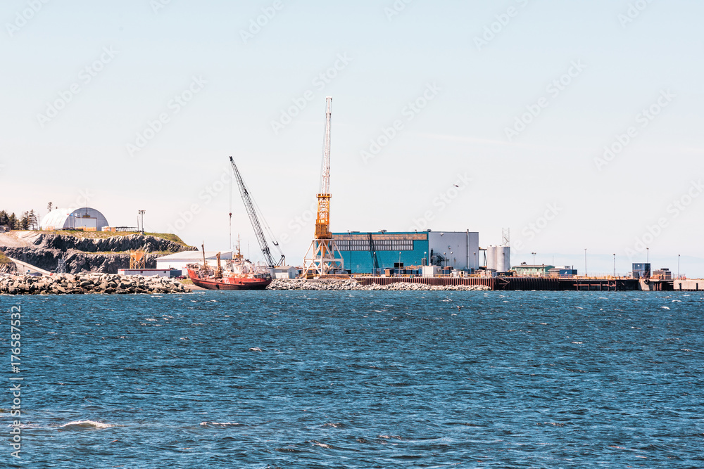 Seaport industrial commercial dock on Gaspesie coast of Quebec Canada with port, ships and construction cranes