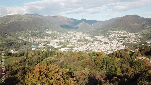 4K Drone aerial view to the villages of Leffe, Gandino, Peia and Cazzano Sant Andrea, located at Gandino Valley, Bergamo, Italy during autumn season photo