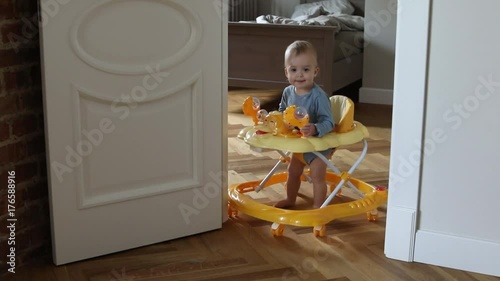 Attractive baby boy playing inside baby walker