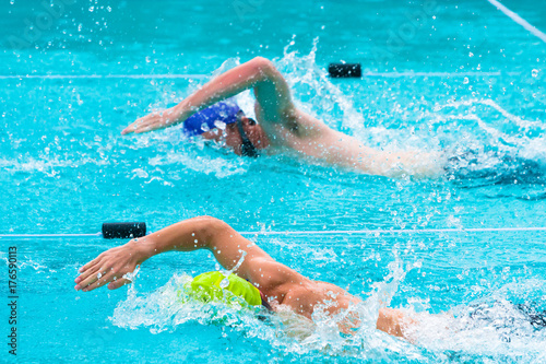 male swimmers competing in freestyle stroke © kudosstudio