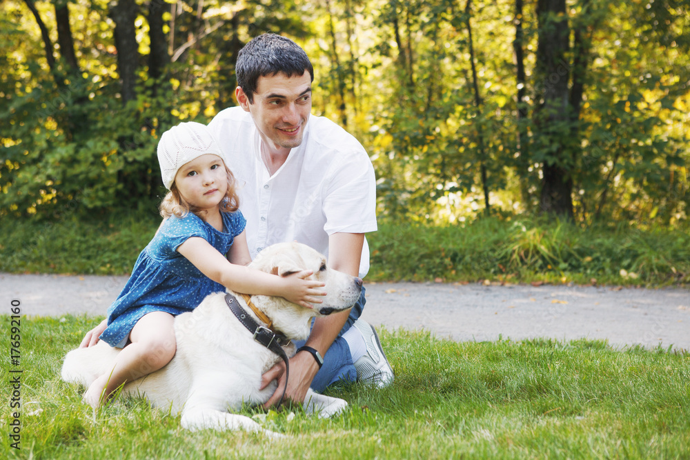 happy family with pet dog at picnic in a Sunny summer day. pregn happy family with pet dog at picnic in a Sunny summer day. pregn