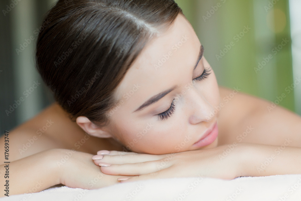 Relaxed girl with closed eyes lying in spa salon before bodycare procedure Relaxed girl with closed eyes lying in spa salon before bodycare procedure