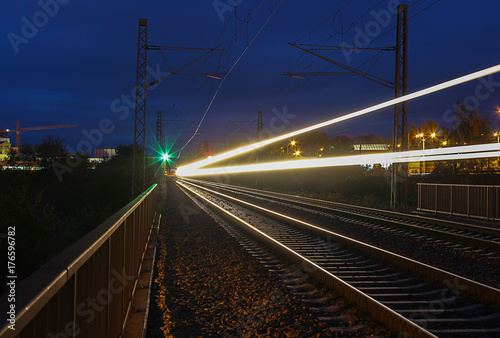 Train trails in night on long exposure with green light