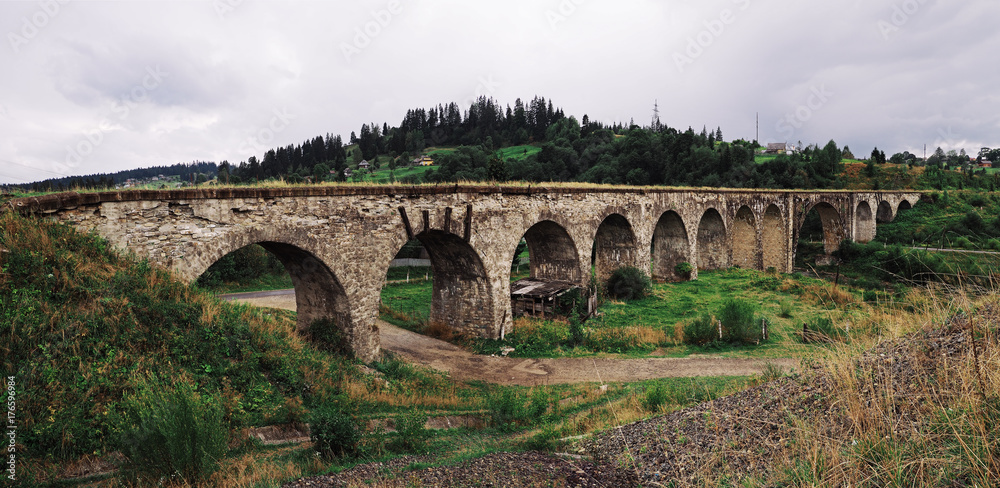 Panorama of the old austrian bridge through the river at the Karpatian mountains view from beginning