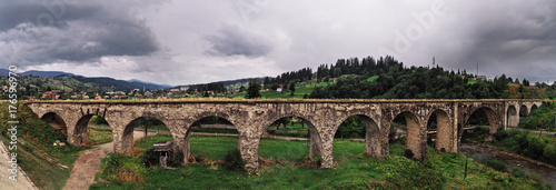 Panorama of the old austrian bridge through the river at the Karpatian mountains