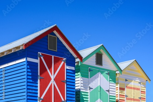 Colorful bunk houses against blue sky background.