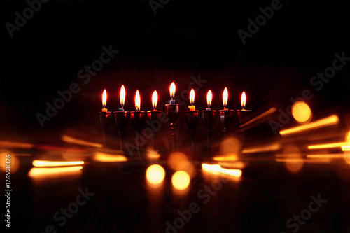 Low key abstract image of jewish holiday Hanukkah background with menorah (traditional candelabra)