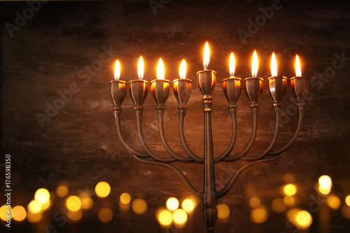 Low key abstract image of jewish holiday Hanukkah background with menorah (traditional candelabra)