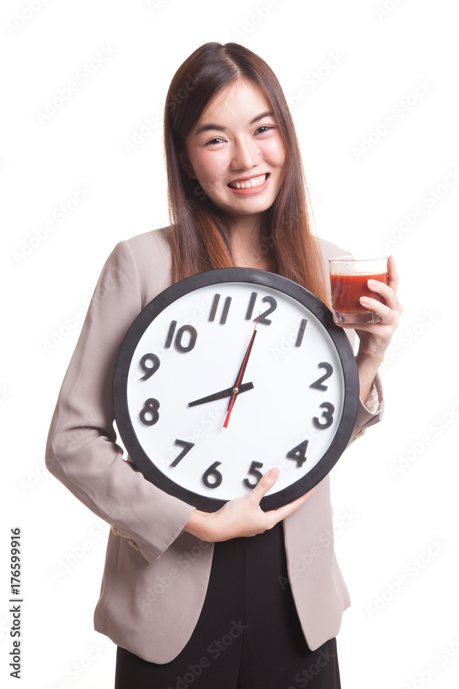 Young Asian woman with tomato juice and clock. Young Asian woman with tomato juice and clock.