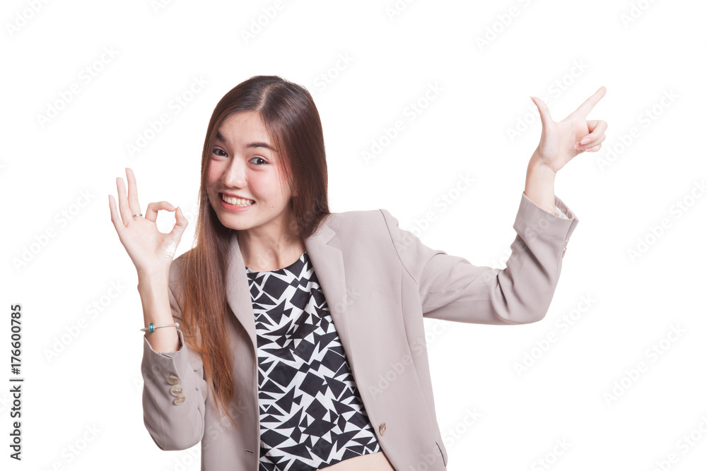 Young Asian woman point and show OK.