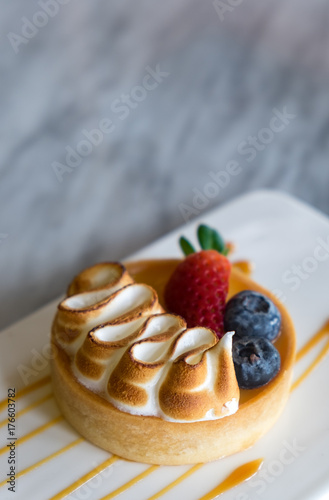 Straeberry and Blueberry fruit tart on plat decorate with caramel sauce. photo