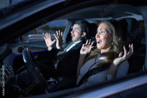 Business couple in car almost having an accident photo