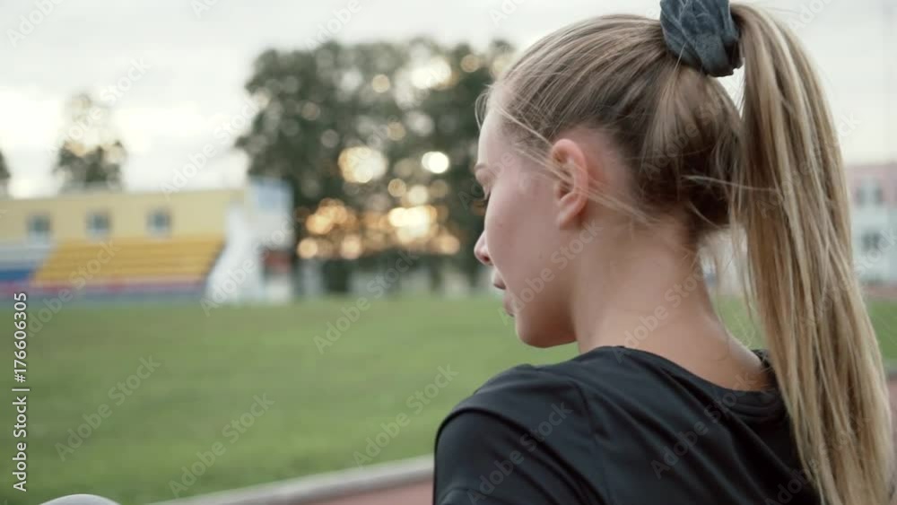 Sportswoman warm up at sport stadium before running competition Sportswoman warm up at sport stadium before running competition
