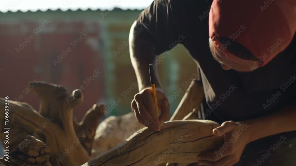 Man make a sketch for wood carving rapid slow motion Man make a sketch for wood carving rapid slow motion