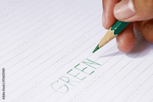 green pencil in blur man's hands