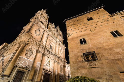 Facade of Casa de las Conchas in Salamanca at night, Spain, covered in scalloped shells, and Salamanca University at illuminated at night. community of castile and león,. World Heritage Site in 1988 photo