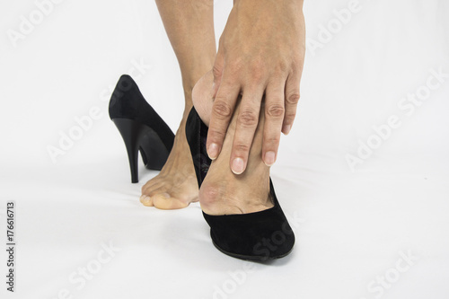 woman wore stilettos. Hallux valgus using narrow shoes.on a white background photo