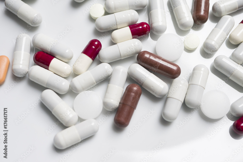 Close up, red, white, brown, medicine pills, isolate, white backgraund Close up, red, white, brown, medicine pills, isolate, white backgraund
