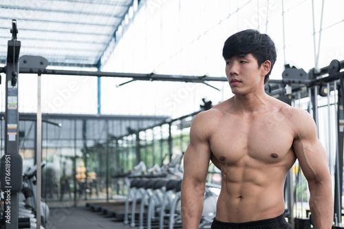 man athlete prepare for training in gym. bodybuilder male working out in fitness center. sport guy doing exercises in health club.