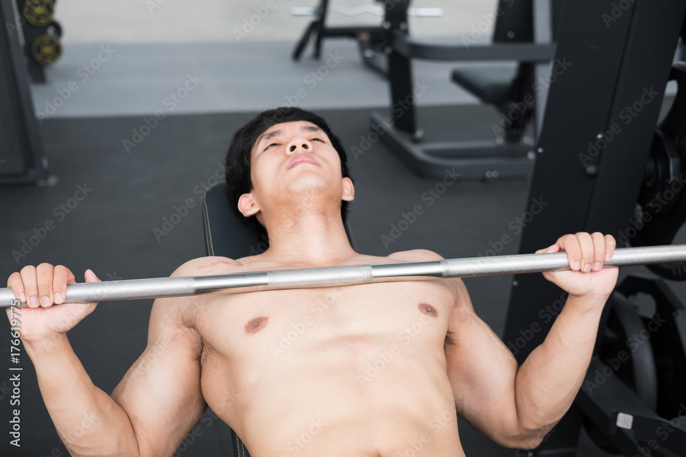 young man execute exercise with weightlifting machine in fitness center. male athlete pump up muscle in gym. sporty guy working out in health club. young man execute exercise with weightlifting machine in fitness center. male athlete pump up muscle in gym. sporty guy working out in health club.