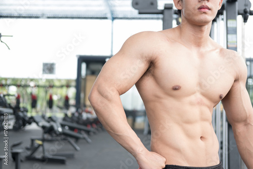 man athlete prepare for training in gym. bodybuilder male working out in fitness center. sport guy doing exercises in health club.