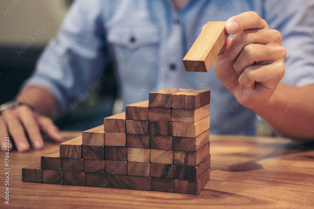 Alternative risk concept, plan and strategy in business, Risk To Make Business Growth Concept With Wooden Blocks, hand of man has piling up and stacking a wooden block Alternative risk concept, plan and strategy in business, Risk To Make Business Growth Concept With Wooden Blocks, hand of man has piling up and stacking a wooden block