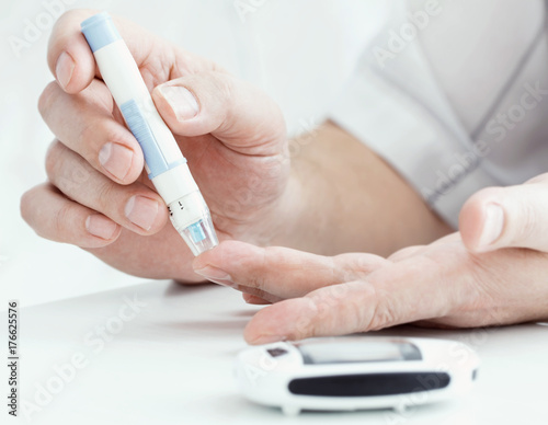 medicine  diabetes  glycemia  health care and people concept - close up of male finger with test stripe
