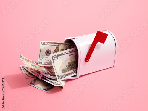 Mailbox containing US Dollar Bills with red flag on pink background