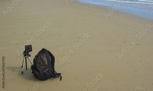 Camera bag and tripod with panoramic head on beach